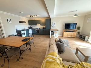 a living room with a couch and a table at Apartment with Swimming Pool in Tenby
