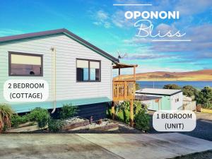 a house with the words openron bliss and bedroom at Opononi Bliss in Opononi