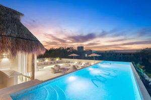 a swimming pool with a view of a resort at Casa Vida Tulum in Tulum