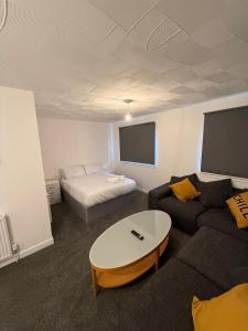 a living room with a couch and a table at 2-Bed City Apartment by Glasgow Green in Glasgow