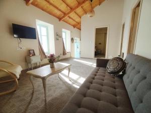 a living room with a couch and a table at Διώροφη κατοικία Γλώσσα Σκοπέλου in Skopelos Town