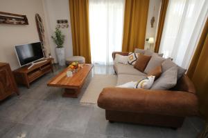 a living room with a couch and a coffee table at Villa Punta Sol with jacuzzi in Jezera