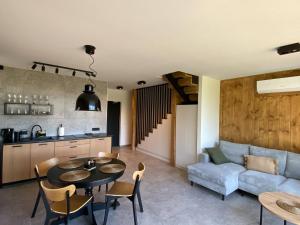 a kitchen and a living room with a table and a couch at elements - Solina, z sauną in Solina
