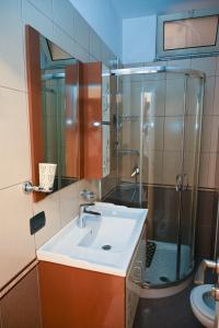 a bathroom with a sink and a shower at Dream House Apartment in Durrës