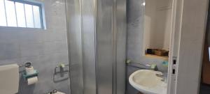 un bagno con lavandino, WC e specchio di Favaro di là 2 a Favaro