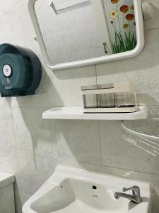 a white bathroom with a sink and a mirror at Yada House twin bed in Nai Yang Beach