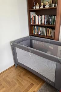 a bed in a room with a book shelf at Apartament przy Parku Czartoryskich - Faktury VAT - parking in Puławy