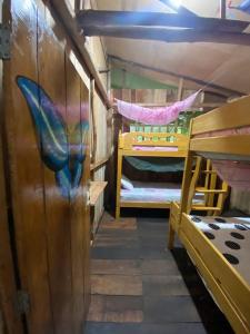 a room with two bunk beds and a whale painted on the wall at YAKU albergue y camping in Padre Cocha +32 photos