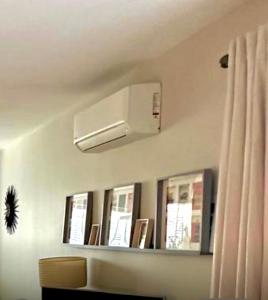 a living room with a air conditioner on the wall at The Duplex with Air Conditioning & Private Deck Area in Margate