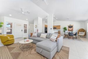 un soggiorno con divano grigio e sedia gialla di Casa Del Sol-Mountain View 3BR Home w Pool Hot Tub a Joshua Tree