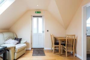 a living room with a couch and a table at Hunter Heights Loft (Countryside Views) in Wroxall