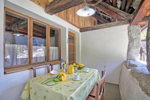 a dining room with a table with a green table cloth at Rustico Val Bavona house - Happy Rentals in Sabbione