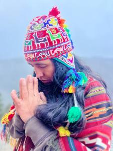 a woman wearing a hat with her hands up at YAKU albergue y camping in Padre Cocha