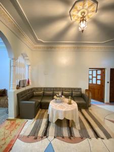 a living room with a couch and a table at The Guests Haven House - Heart Of Skoura in Skoura