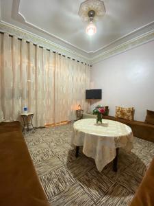 a living room with a table and a couch at The Guests Haven House - Heart Of Skoura in Skoura