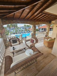 an outdoor patio with furniture and a pool at Villa Belle ,Fethiye in Fethiye