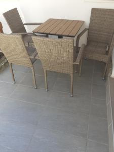a wooden table and chairs on a patio at Smestaj Stankovic in Soko Banja +20 photos