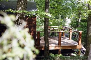 a wooden deck with a picnic table sitting on it at Kisvacok tiny house in Kismaros