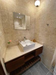 a bathroom with a white sink and a mirror at Boutique Hotel Casa Grande, Mango Tango Suite in Santo Domingo +5 photos
