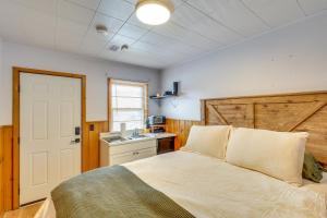 a bedroom with a bed and a kitchen with a sink at 2 Mi to Black Hills Natl Forest Convenient Pad! in Spearfish +16 photos