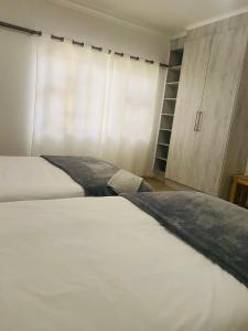 Ένα ή περισσότερα κρεβάτια σε δωμάτιο στο Bay Family Nest +1 φωτογραφίες