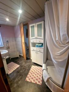 a small bathroom with a sink and a shower at FeWo altes Pfarrhaus in Erndtebrück +6 photos