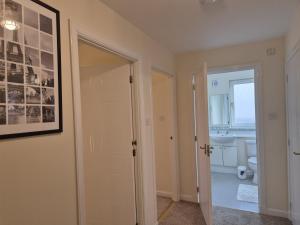 a bathroom with a toilet and a window and a door at Spacious Modern 2-BR Apartment in Aberdeen City Centre in Aberdeen +28 photos