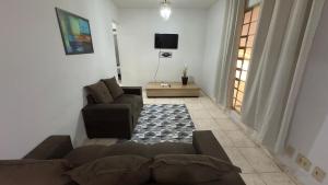 a living room with a couch and a table at Casa da Sementes in Uberlândia