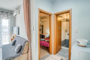 a bathroom with a shower and a bedroom at Mrs, Aphrodite's Studio in Chios