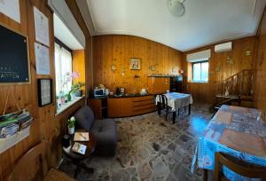 a room with wooden walls and a kitchen with a table at Malpensa Bed & Breakfast-No Breakfast in Case Nuove