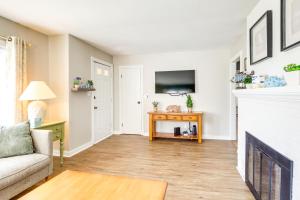 a living room with a couch and a fireplace at Walk to Private Beach and Boat Launch Mayfield Home in Broadalbin
