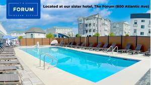 a pool at a hotel with chairs around it at The Surf Club in Ocean City