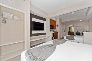 a bedroom with two beds and a flat screen tv at 2 Units Together Kitchen Great Location in Orlando