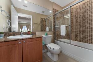 a bathroom with a toilet and a sink and a shower at 2 Units Together Kitchen Great Location in Orlando