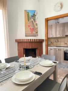 a dining room table with plates and glasses on it at Nicole's House in Vieste +15 photos