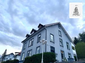a blue building with a clock on the side of it at Pension in Beuggen