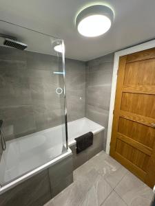 StoughtonにあるContemporary Comfort 2 Bed Homeのバスルーム(バスタブ、ガラスドア付きのシャワー付) +18枚の写真