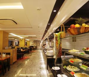 a restaurant with a buffet line of food at Effotel By Sayaji Indore in Indore