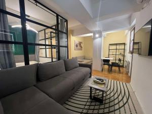 a living room with a couch and a table at Gigi Apartment by eluxory in Skopje