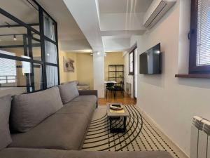 a living room with a couch and a table at Gigi Apartment by eluxory in Skopje