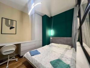 a small bedroom with a bed and a desk at Gigi Apartment by eluxory in Skopje