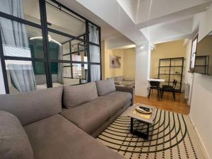 a living room with a couch and a table at Gigi Apartment by eluxory in Skopje