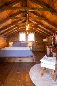 a bedroom with a bed in a wooden cabin at Chalé Morada dos Tucanos in Santo Amaro da Imperatriz +130 photos