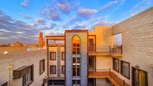 a view of a building with a clock tower at Hotel Bankir Khiva in Khiva