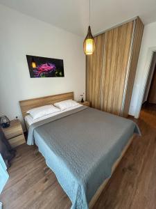 a bedroom with a large bed in a room at Sea & Stone Edge Suites in Dobra Voda