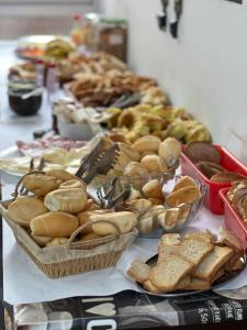 a table topped with baskets of bread and pastries at POUSADA MIRAMAR in Arraial do Cabo +3 photos
