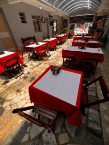 a row of tables in a room with red tables at POUSADA MIRAMAR in Arraial do Cabo +13 photos