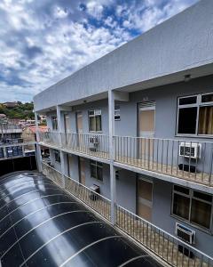a building with a water tank in front of it at POUSADA MIRAMAR in Arraial do Cabo