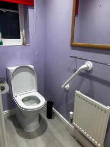 a bathroom with a white toilet and a radiator at Private Room in Newmarket in Newmarket