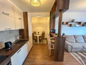 a kitchen and living room with a couch and a table at Sea & Stone Edge Suites in Dobra Voda